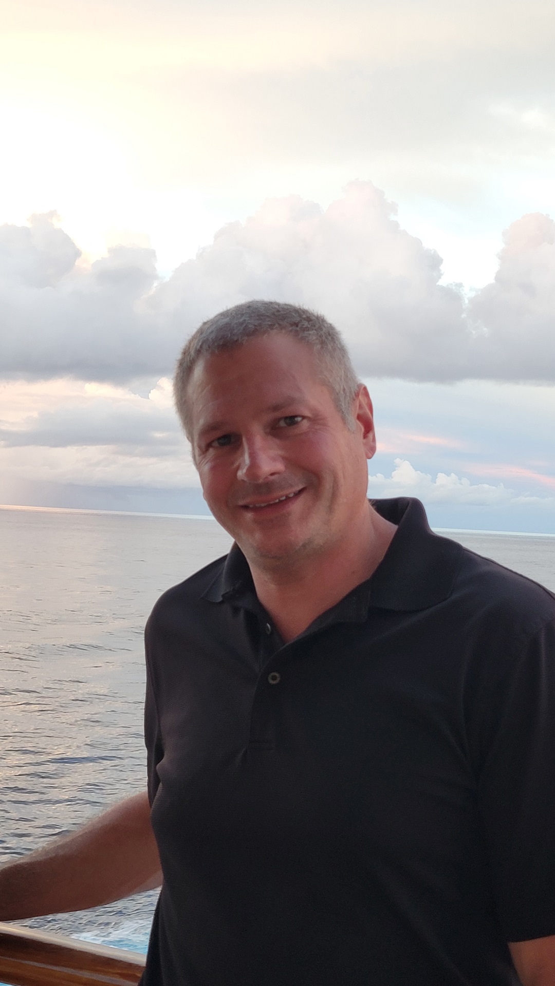 Eric Putnam, circular-style profile photo, smiling in a dark polo shirt
